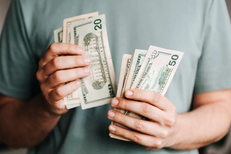 Person counting cash — the real cost of losing customers to poor communication